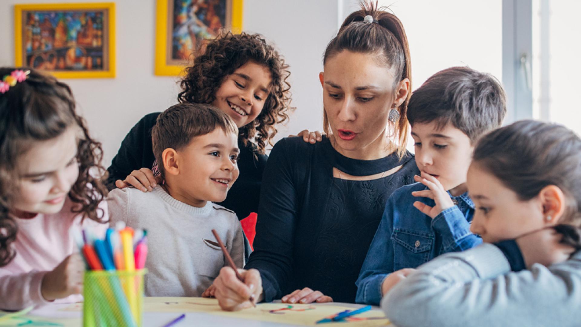 teacher showing kids the Farsi alphabet