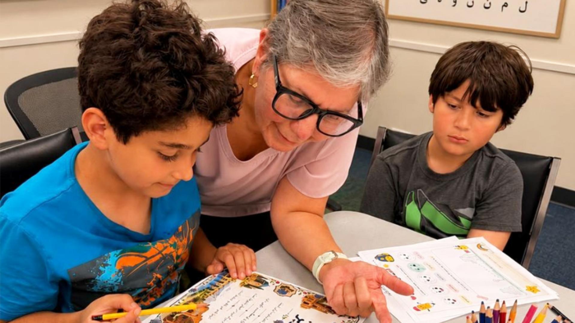 Instructor showing kids crafts