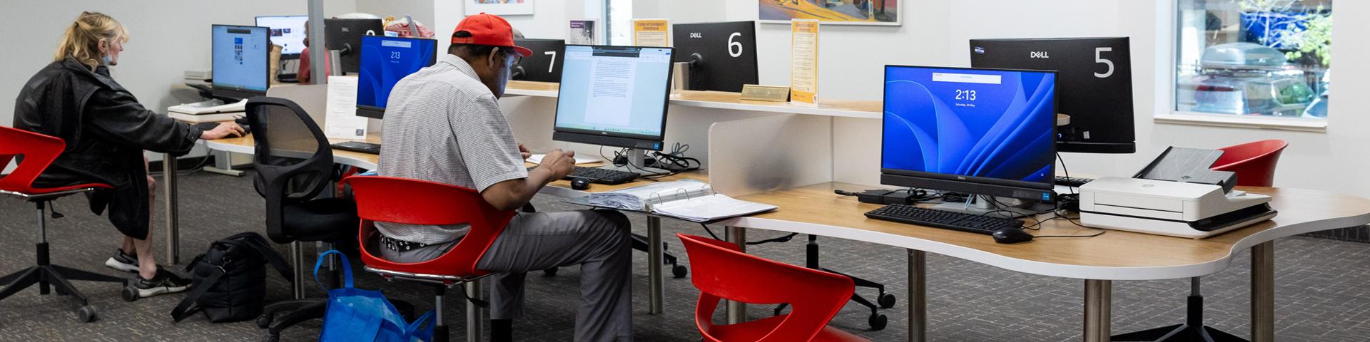 People using publc computers on the Library's main floor