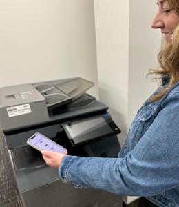 Person with mobile device doing wireless printing